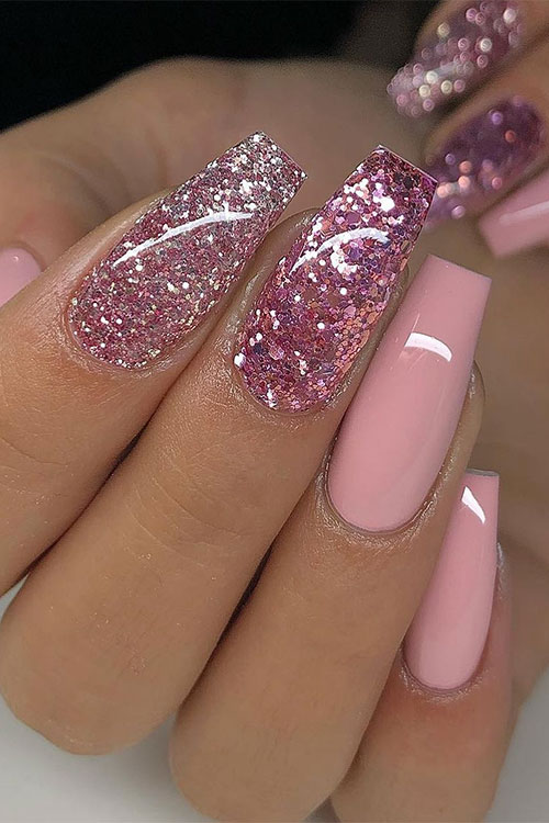 Long nude pink coffin nails with design feature two accents of rose gold glitter nails Long nude pink coffin nails with design feature two accents of rose gold glitter nails
