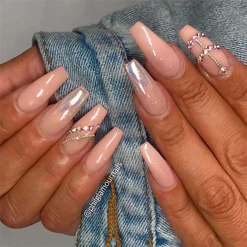 Nude coffin nail art design with gold rhinestones on accent nail and second accent nail with holographic chrome tip