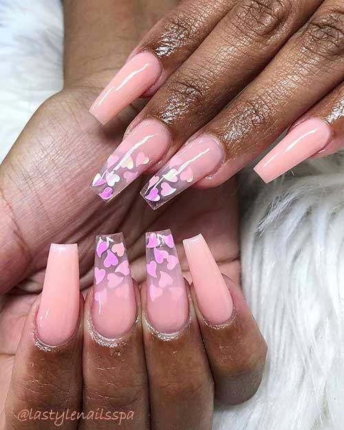 Nude coffin nails for valentine's day with heart shaped glitter flakes on dark skin