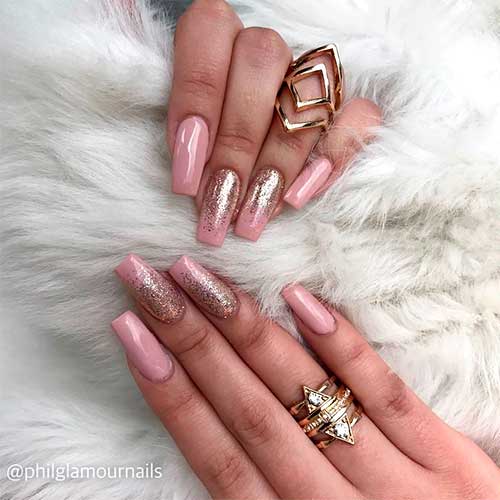 Nude pink coffin nails 2020 with gold glitter on two accent nails