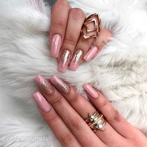 Nude pink coffin nails 2020 with gold glitter on two accent nails Nude pink coffin nails 2020 with gold glitter on two accent nails