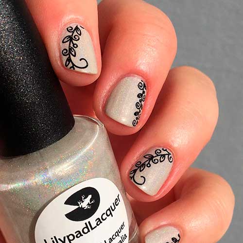 Short white holographic nails 2020 design with print stamping on nails Short white holographic nails 2020 design with print stamping on nails