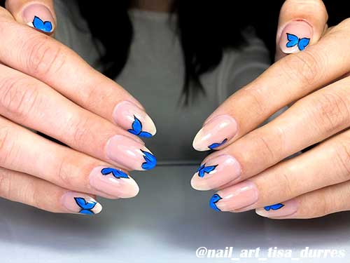 Simple nude almond shape butterfly nails 2020 with blue butterflies for spring season