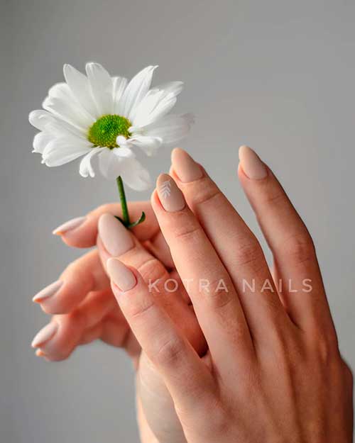 Spring nude almond acrylic nails short with white leaves on accent nail Spring nude almond acrylic nails short with white leaves on accent nail