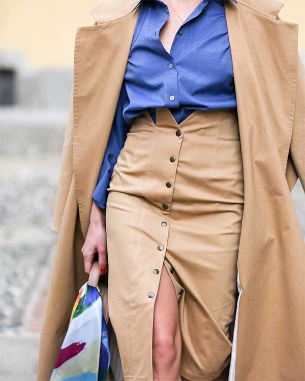 Pencil Skirt Outfit for Work Idea consists of camel colored midi pencil skirt with front snap fasteners and a blue blouse