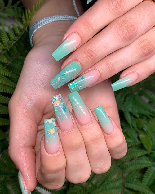 Coffin shaped mint green ombre nails 2020 with two accent nails adorned with some glitter for summer 2020