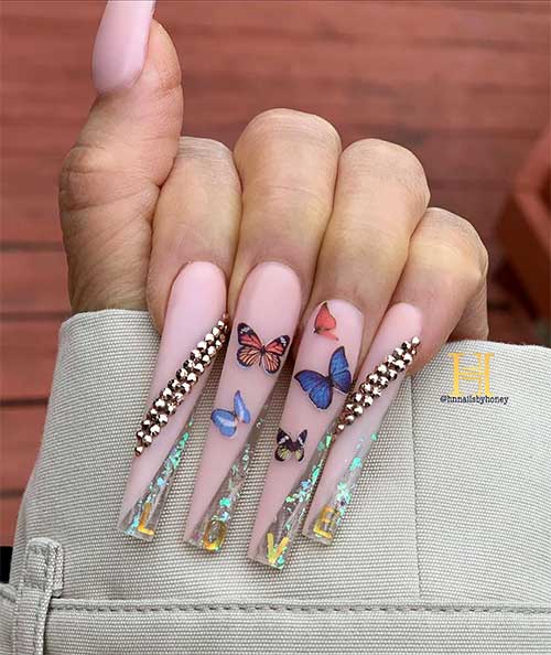 Gorgeous long coffin nude nails with glitter, rhinestones, and butterfly decals!