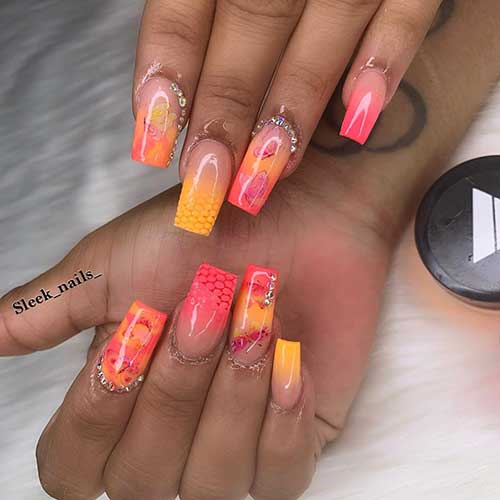 Orange and yellow ombre nails 2020 with butterfly stamping nail art and some rhinestones