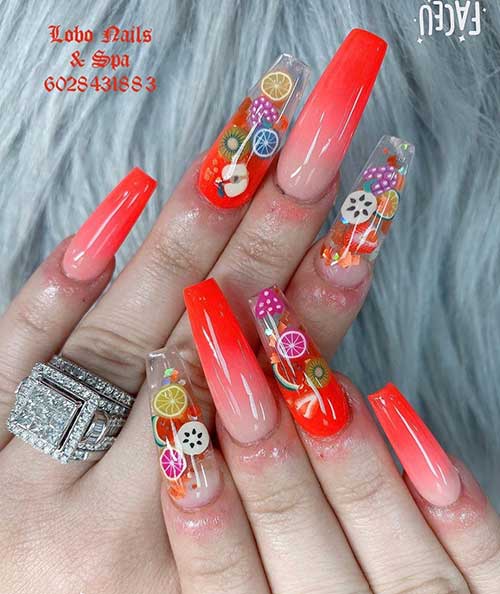 Amazing summer ombre orange nails 2020 that consists of orange ombre nails coffin shaped design with fruit stickers over two accent clear nails!