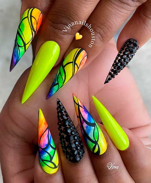 Cute neon yellow stiletto nails with mixed neon ombre nails colors for summer and black rhinestones on accent bare nail!