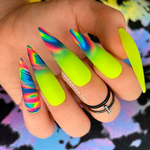Long Stiletto Neon Yellow Nails 2021 with Neon Swirls on tips besides the accent neon swirls nail