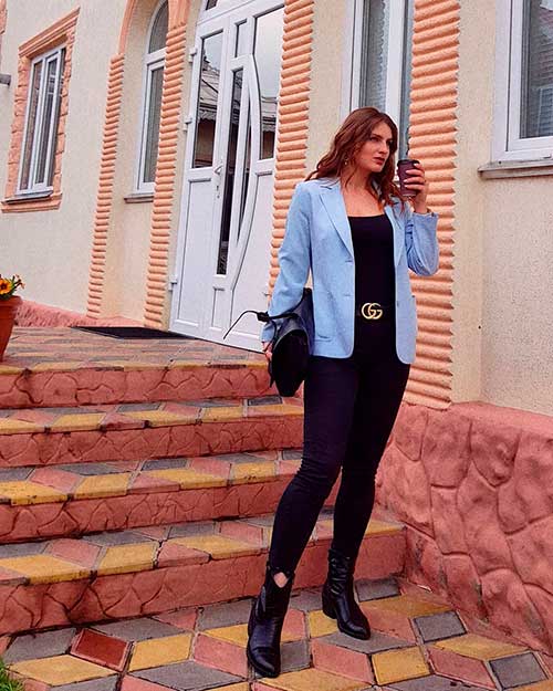 Light blue blazer over a black top and pants creating one of the best autumn outfits ideas for women