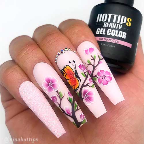 Coffin shaped matte pink nails with blossom and butterfly nail art design which adorned with little silver rhinestones! Coffin shaped matte pink nails with blossom and butterfly nail art design which adorned with little silver rhinestones!