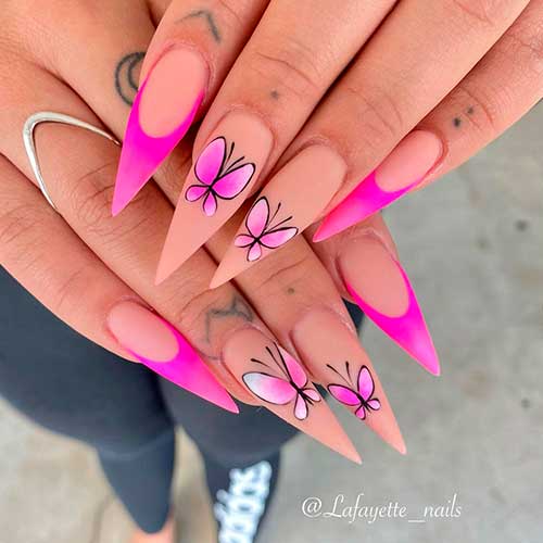 Cute Stiletto pink acrylic nails 2021 with butterfly nail art on two accent nude nails for spring 2021!