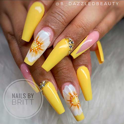 Glossy Yellow Nails 2021 with A Big White Flower on accent nail, accent V French nail, and adorning rhinestones