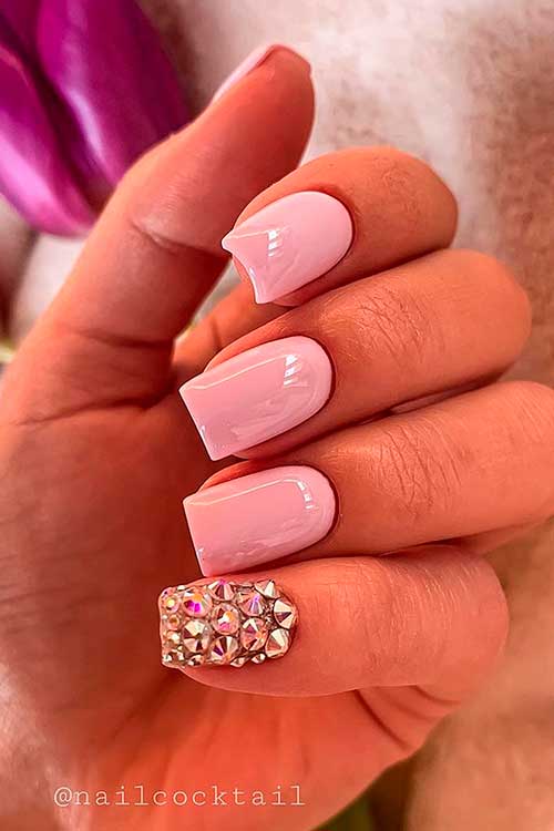 One of the simplest pink nail designs 2021 that decorated with gold glitter and rhinestones on accent nail!