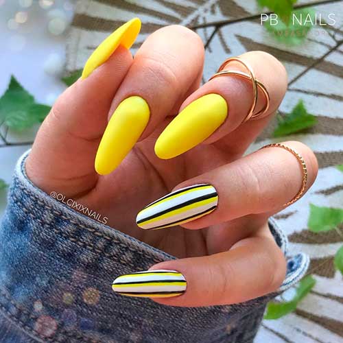 Perfect almond shaped bright yellow summer nails 2021 with two accent striped nails for sunny summer days! 