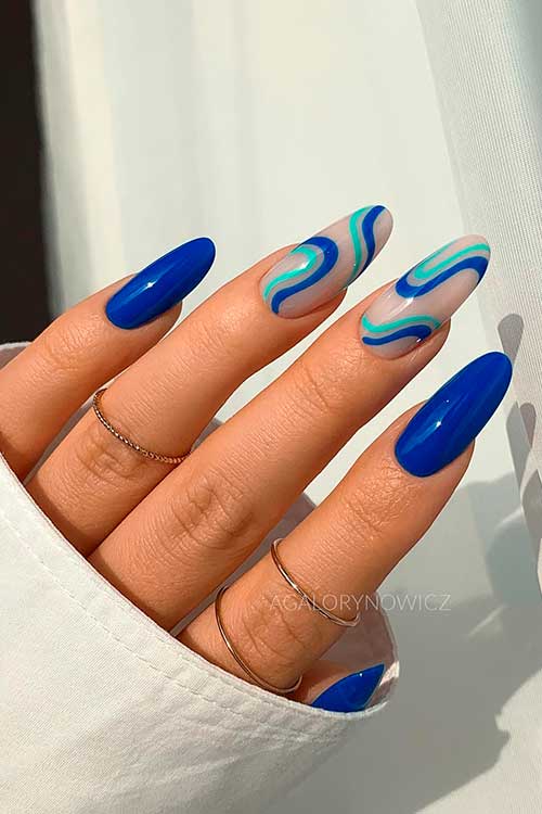 Long Summer Royal Blue Nails Design with Two Swirl Accents on Nude Base Color for Summer 2022