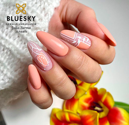 Almond shaped peach nails 2021 with accentuated leaf nail art and floral nail art for summer 2021