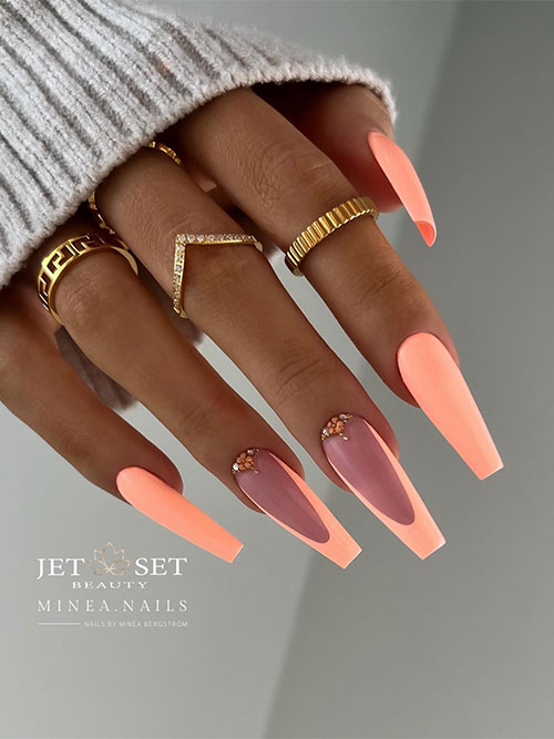 Long coffin neon peach nails with two accent peach French tips adorned with tiny flowers and rhinestones above cuticles Long coffin neon peach nails with two accent peach French tips adorned with tiny flowers and rhinestones above cuticles