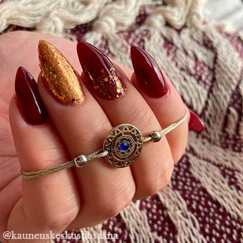 Glossy Dark Red Fall Nails with Gold Glitter Considered Classy Autumn Nails