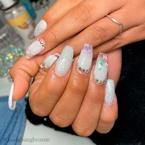 Gorgeous white acrylic nails coffin shaped with glitter and butterfly nail art