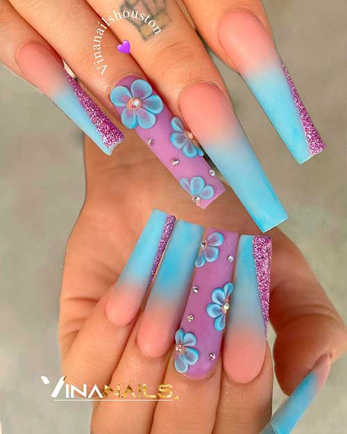 Multicoated Colours of Purple Blended with blue ombre nails Accentuated with Flowers and Diamonds