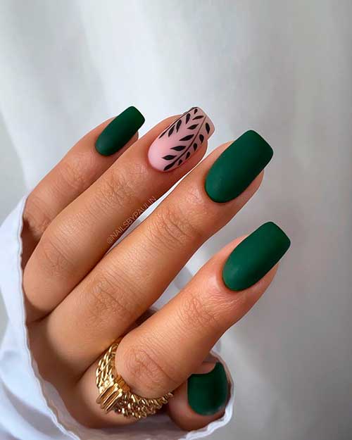 Cute square shaped matte dark green nails with black fall leaves on accent nude pink nail