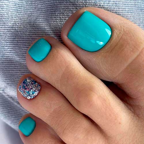 Glossy Turquoise pedicure idea with confetti glitter accent toenail design which is the best of pedicure ideas 2021 to try