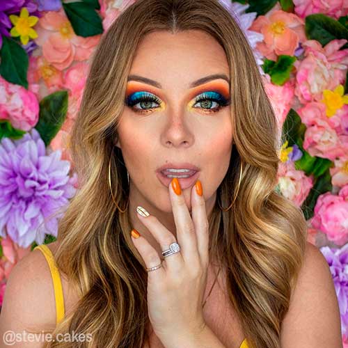 Orange You Glad Fall Makeup Look Gorgeous colorful fall makeup looks 2021 that uses orange, yellow, and blue eyeshadows