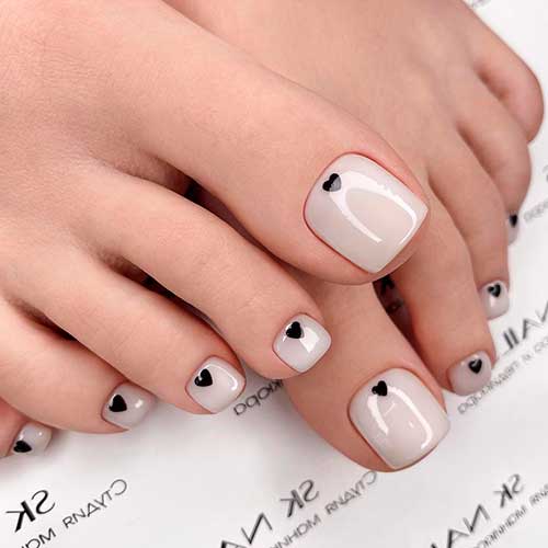 Gorgeous Glossy Nude Pedicure 2021 with a Black Heart Design