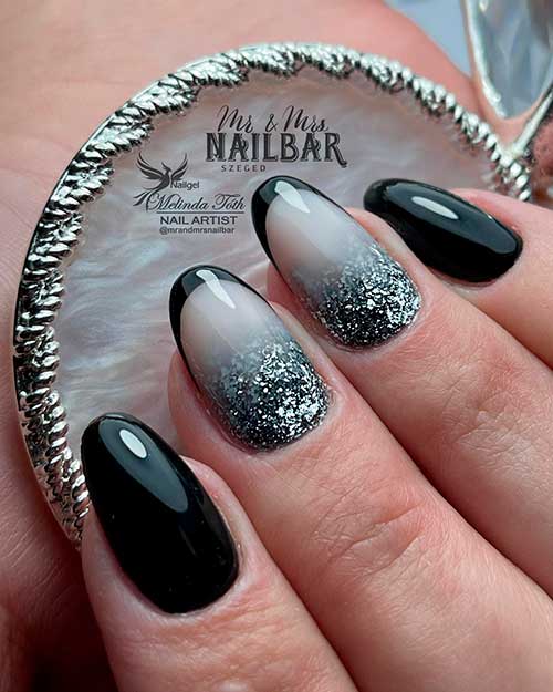 Medium round black nails with two accent black French nails adorned with silver glitter