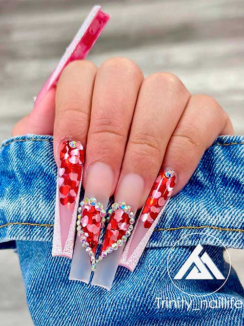 Long White Glitter V French valentines day nails 2022 with pink and red heart glitter and crystals over clear acrylics Long White Glitter V French valentine's day nails with pink and red heart glitter and crystals over clear acrylics