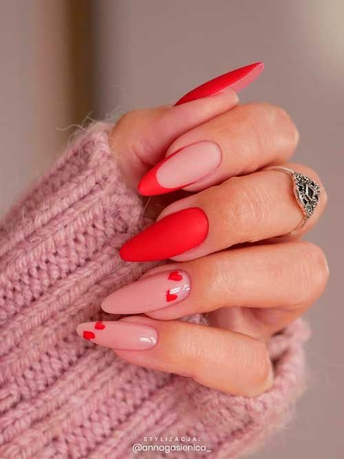 Nude and matte red valentines day nails almond shaped with small red hearts design