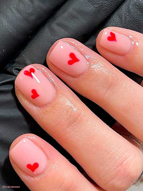 Short nude simple valentines day nails 2022 with red hearts design Short nude simple valentines day nails 2022 with red hearts design