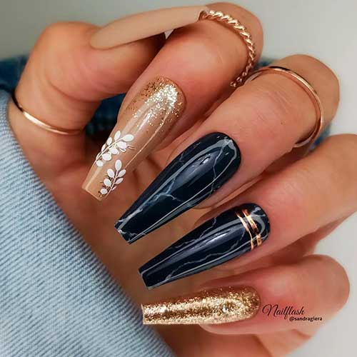 Long Nude and black marble coffin nails with gold glitter accent and white leaves on another accent nail