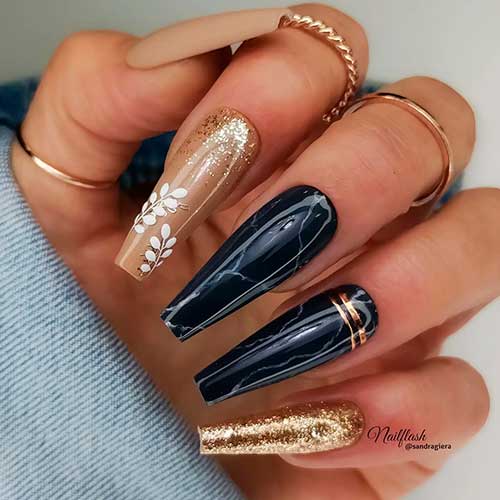 Long Nude and black marble coffin nails with gold glitter accent and white leaves on another accent nail Long Nude and black marble coffin nails with gold glitter accent and white leaves on another accent nail