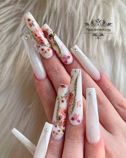 Long coffin white spring V French tip nails with rhinestones, and two accent butterflies and flower nails with gold glitter
