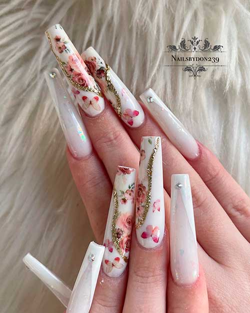 Long coffin white spring V French tip nails with rhinestones, and two accent butterflies and flower nails with gold glitter Long coffin white spring V French tip nails with rhinestones, and two accent butterflies and flower nails with gold glitter