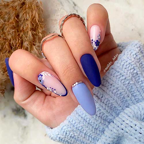 Matte Blue Almond Spring Nails with Rhinestones, and Two Accent Floral Nails with Nude Pink Base Color