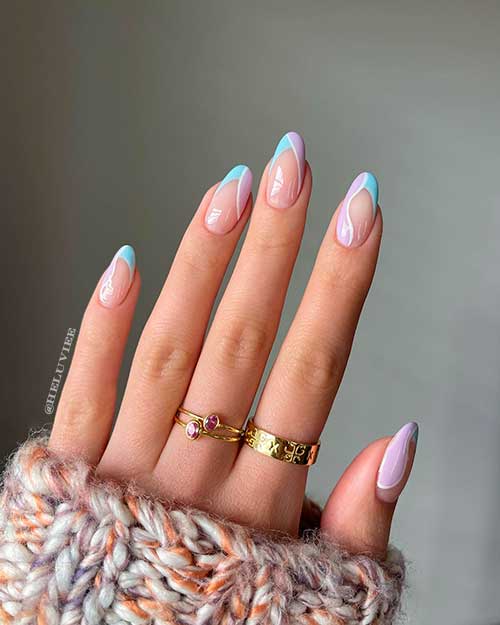 Medium round pastel nails consists of French baby blue nails with lavender swirls outlined in a white line design Medium round pastel nails consists of French baby blue nails with lavender swirls outlined in a white line design