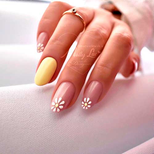 Medium round spring white flower nails with accent matte yellow nail that considered best of spring nails 2022