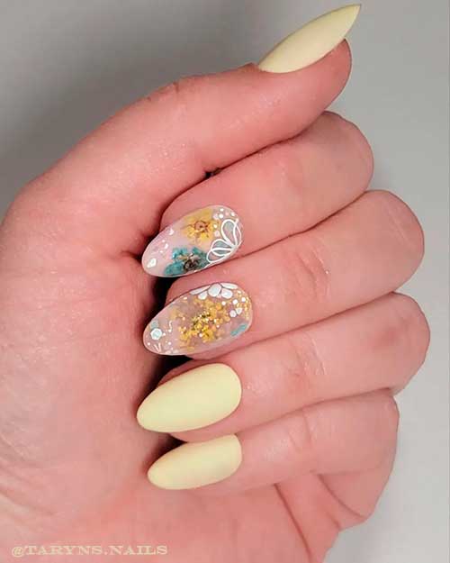 Short almond matte pastel yellow spring nails with two accent flower nails design Short almond matte pastel yellow spring nails with two accent flower nails design