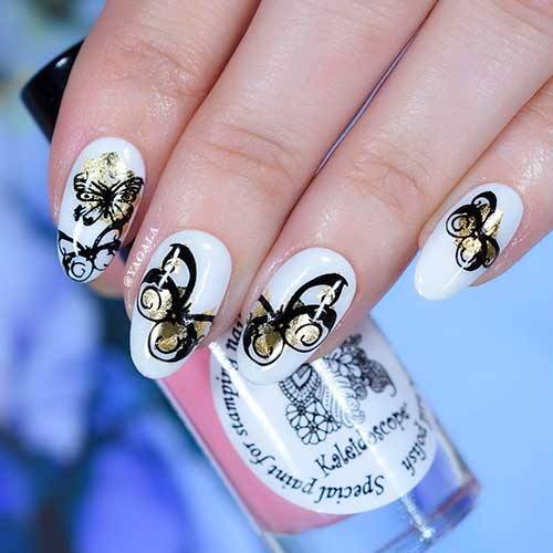 Cute black and gold butterflies on short round white nails design for spring and summer 2022