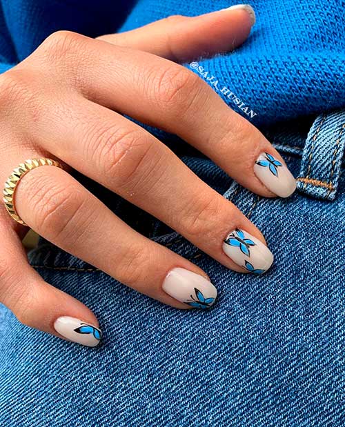 Cute blue butterfly nails short over nude square nails for spring and summer 2022