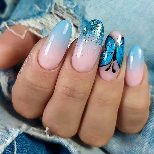 Long round pink blue ombre nails with glitter and butterfly nails for spring and summer seasons