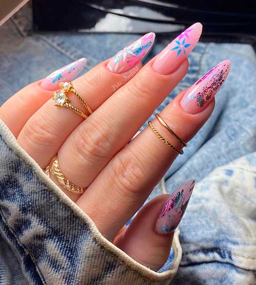 Long almond nude pink nails with colorful foil patches and two accent colorful blossom nails