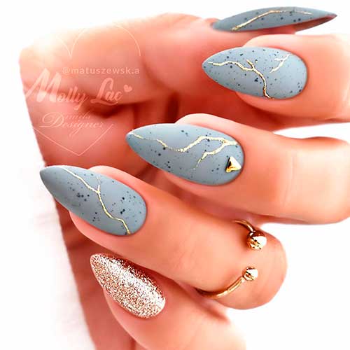 Stiletto Matte Grey Nails with Black Flecks, Golden Lines, A Golden Rhinestones, and Accent Glitter Nail design