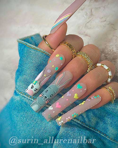 Long Cute Easter Nails Design Long Cute Easter Nails Design with bunnies, Flowers, Heart shapes, and a rainbow on the thumb fingernail
