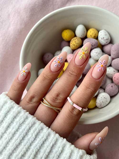 Long almond-shaped nude spring Easter nails 2023 with cute mini egg daisies